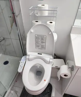a bathroom with a toilet with a remote control at 2 bedrooms luxury basement suite close to Calgary airport in Calgary