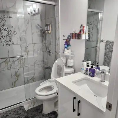 a bathroom with a toilet and a shower and a sink at 2 bedrooms luxury basement suite close to Calgary airport in Calgary