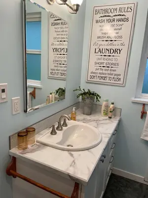a bathroom with a sink and a mirror at Oyster River Guest Room in Campbell River