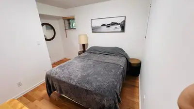 a small bedroom with a bed in a room at Oceanfront Garden Suite - Stunning Views & Wildlife in Halfmoon Bay