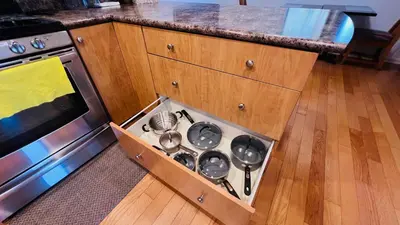 a kitchen with a drawer with pots and pans in it at Oceanfront Garden Suite - Stunning Views & Wildlife in Halfmoon Bay