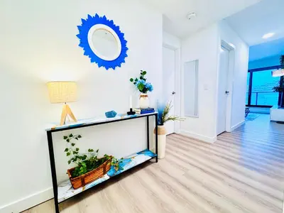 a living room with a fish tank and a mirror at Bow River Cabin - Downtown - River Front - Free Street Parking in Calgary