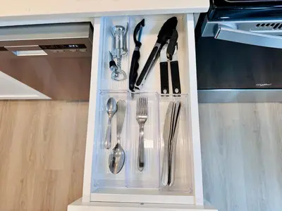 a drawer filled with utensils in a kitchen at Bow River Cabin - Downtown - River Front - Free Street Parking in Calgary