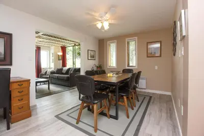 a dining room and living room with a table and chairs at Cole's Bay Vacation Retreat Cole's Bay Suite in YYJ