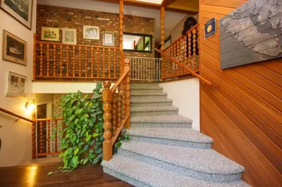 a staircase in a house with a green plant at Cole's Bay Vacation Retreat Cole's Bay Suite in YYJ