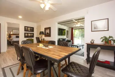 a dining room and living room with a table and chairs at Cole's Bay Vacation Retreat Cole's Bay Suite in YYJ