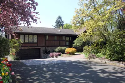 a driveway leading to a house with a garage at Cole's Bay Vacation Retreat Petie's Cottage in YYJ