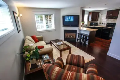 a living room with a couch and a fireplace at Grand Boulevard Retreat- quiet suite in North Vanc in North Vancouver