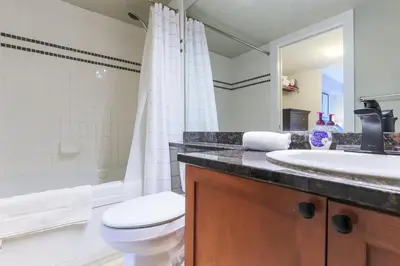 a bathroom with a toilet and a sink at Whistler Village North Retreat - Private Hot tub in Whistler