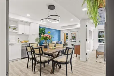a kitchen and dining room with a table and chairs at Newly Built 2BR Mountain Escape in DT Canmore! in Canmore