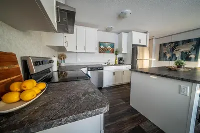 a kitchen with a plate of fruit on a counter at 3 Bed Townhouse, Mountain Views, Large Deck, Air Con, Garage in Invermere