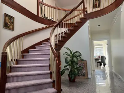 a spiral staircase in a home with a plant at Spacious Bedroom with Two Queen Sized Bed in Richmond