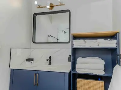 a bathroom with a sink and a mirror and towels at Private one Bedroom Suite for Rent in Calgary