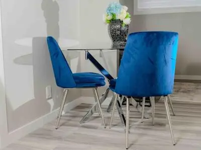 two blue chairs sitting next to a glass table at Private one Bedroom Suite for Rent in Calgary