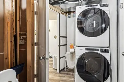 a washing machine and a washer in a room at Basement Suite in Calgary - Short Drive to Banff in Calgary