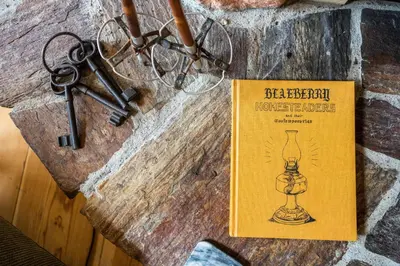 a book sitting on a wall with a key at Moberly Lodge in Golden