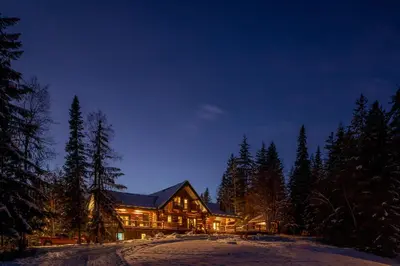 a large house in the woods at night at Moberly Lodge in Golden