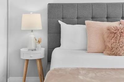 a bedroom with a bed with a lamp on a side table at Fabulous Home-King bed-Easy Access to EVERyTHING! in Edmonton