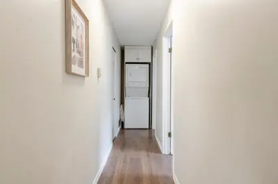 a hallway with white walls and a refrigerator at Oak Park House in Vancouver in Vancouver