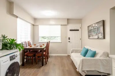 a kitchen and dining room with a table and a couch at Oak Park House in Vancouver in Vancouver
