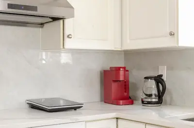 a red blender sitting on a counter in a kitchen at Oak Park House in Vancouver in Vancouver