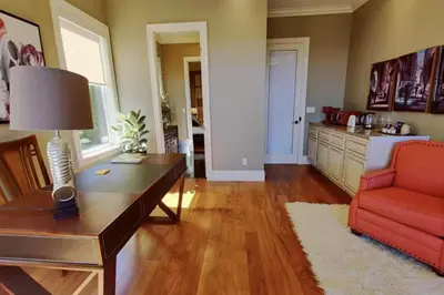 a living room with a red couch and a table at Stunning view in elegant 1 bedroom suite in West Vancouver