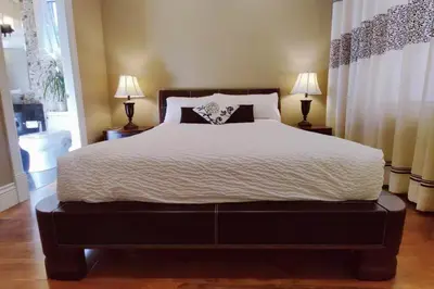a bedroom with a large bed with two lamps at Stunning view in elegant 1 bedroom suite in West Vancouver