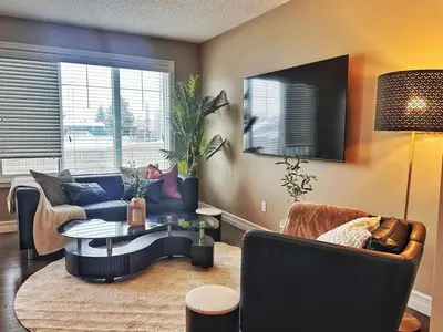 a living room with a couch and a table and chairs at Entire Beautiful and Cozy Home in Edmonton