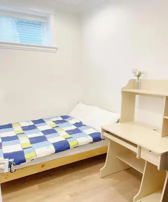 a small bedroom with a bed and a desk at Beautiful place with Kitchen, Washing Machine, Internet near UBC, beach and DT in Vancouver