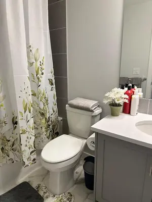 a white bathroom with a toilet and a sink at Modern & Stylish Private Suite in Pine Creek in Calgary