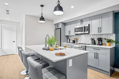 a kitchen with a large island with a plate of food on it at Charming 2BR Haven in Canmore Near DT and Banff in Canmore