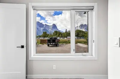 a window with a view of a truck outside at Charming 2BR Haven in Canmore Near DT and Banff in Canmore