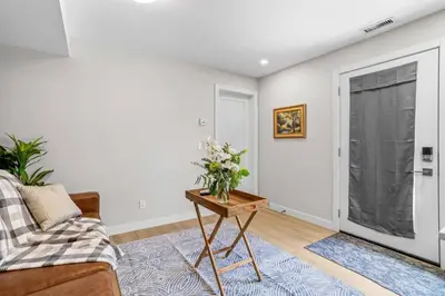 a living room with a couch and a table with flowers at Charming 2BR Haven in Canmore Near DT and Banff in Canmore