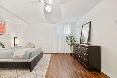 a bedroom with a bed and a dresser and a mirror at 1 Bedroom Cozy Retreat - Queen Bed, Pet Friendly, Smart TV, Secure & Private Access, Free Parking, Netflix & More! in Calgary