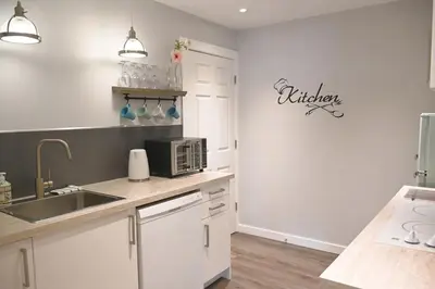 a kitchen with a sink and a microwave at Desert Pines Holiday Getaway in Peachland
