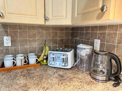 a kitchen counter with a toaster and other appliances on it at Lovely 2BR BSMT Suite w Parking for Pickup in North Vancouver