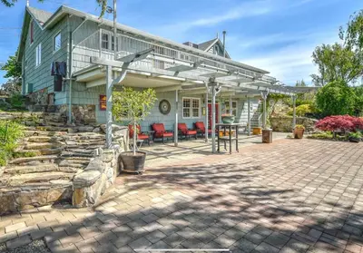 a house with a stone patio in front of it at Blackbird Glen Bed and Breakfast, Glenmore, Kelowna, BC in Kelowna