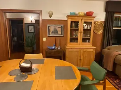 a living room with a wooden table and chairs at Blackbird Glen Bed and Breakfast, Glenmore, Kelowna, BC in Kelowna