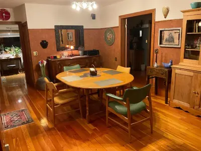 a dining room with a wooden table and chairs at Blackbird Glen Bed and Breakfast, Glenmore, Kelowna, BC in Kelowna