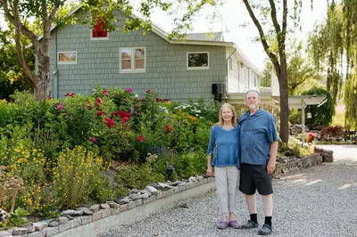 a man and woman standing in front of a house at Blackbird Glen Bed and Breakfast, Glenmore, Kelowna, BC in Kelowna