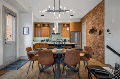 a kitchen and dining room with a table and chairs at Rare Find, Double King Beds, Cozy and Vibrant in Calgary