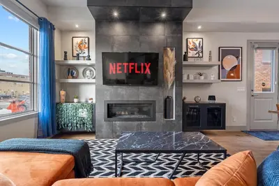 a living room with a fireplace and a tv at Rare Find, Double King Beds, Cozy and Vibrant in Calgary