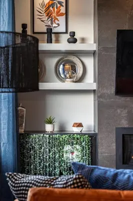 a living room with a fireplace with a mirror at Rare Find, Double King Beds, Cozy and Vibrant in Calgary