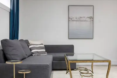 a living room with a couch and a table at Cozy BSMT suite Near UBC, Kits, and DT Vancouver in Vancouver