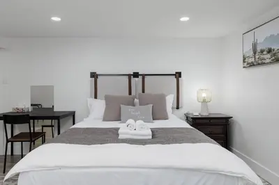a bedroom with a bed with two towels on it at Cozy BSMT suite Near UBC, Kits, and DT Vancouver in Vancouver