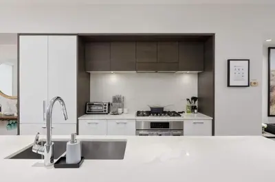 a kitchen with a sink and a stove at Luxury home near DT and YVR w 2 indoor parking in Vancouver