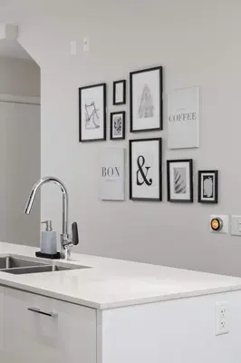 a kitchen with a sink and framed pictures on the wall at Luxury home near DT and YVR w 2 indoor parking in Vancouver