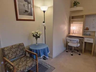 a room with a table with a chair and a desk at Meadow Ridge Haven in Maple Ridge District Municipality