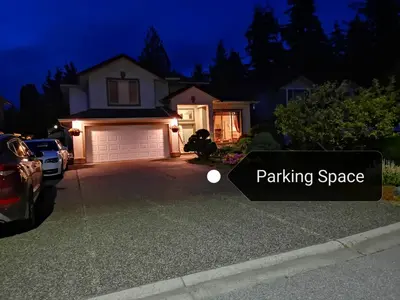 a house with a parking space sign in front of it at Meadow Ridge Haven in Maple Ridge District Municipality