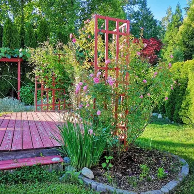 a garden with a red gate and a bunch of flowers at Meadow Ridge Haven in Maple Ridge District Municipality